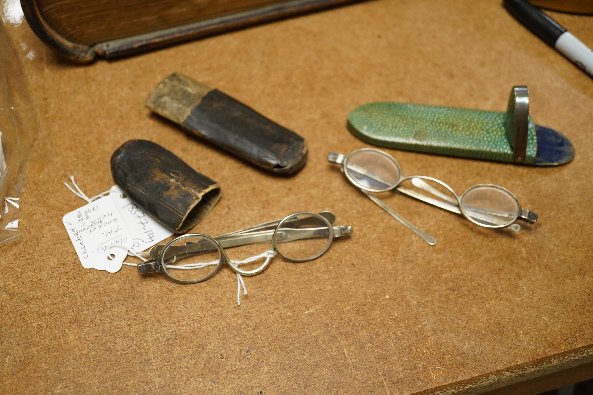 A pair of George III silver framed turn pin spectacles, mm. IH, London 1816, shagreen case, a pair of William IV silver slider spectacles by Thomas Millington, Birmingham, card case (2)